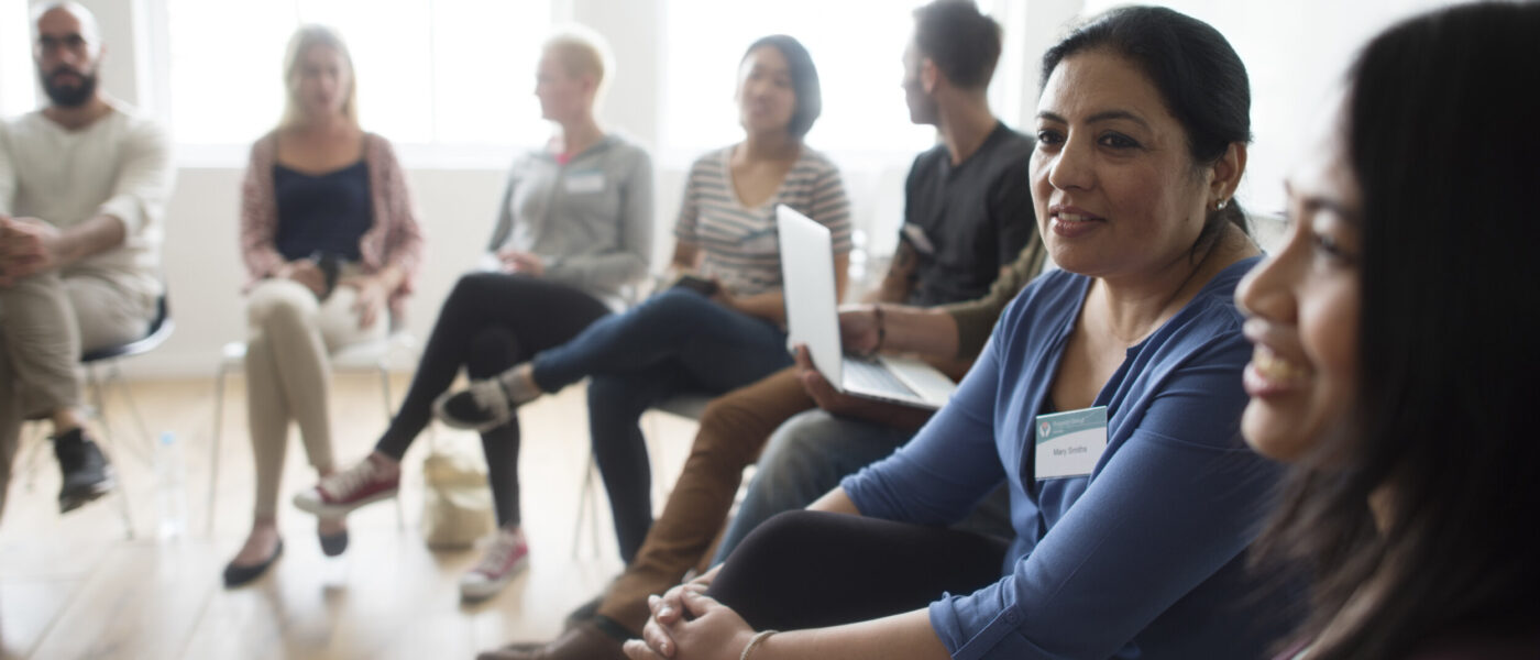 Individuals sitting in a circle in a group discussion setting