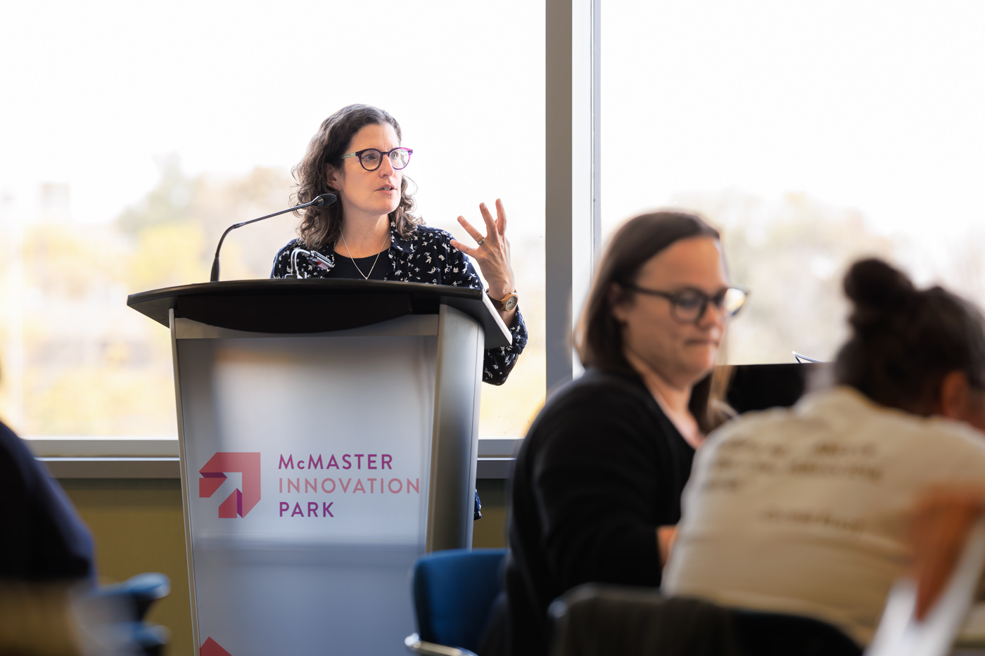 Julia Abelson speaking at podium at the Public Engagement in Health Policy Project Community Fellowship Event on October 27, 2023.